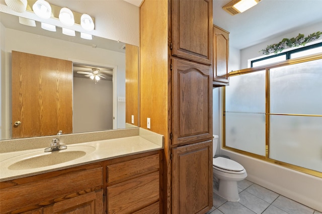 full bathroom with toilet, enclosed tub / shower combo, vanity, and tile patterned floors