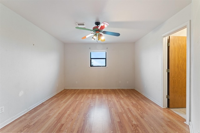 spare room with visible vents, baseboards, light wood-style flooring, and a ceiling fan