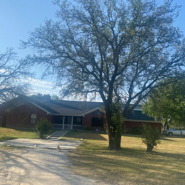 ranch-style home with a front yard and driveway