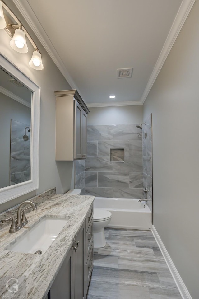 full bathroom with tiled shower / bath combo, crown molding, and vanity