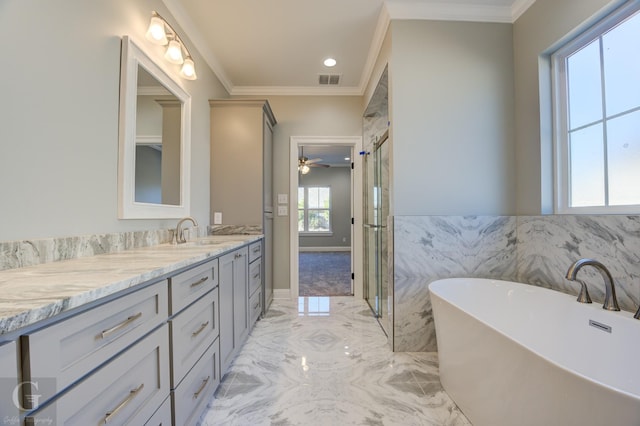 bathroom featuring vanity, crown molding, and a bathing tub