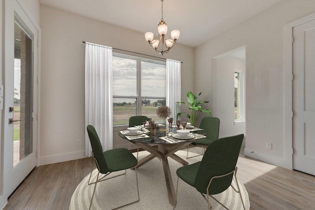 dining room with a notable chandelier and light hardwood / wood-style flooring