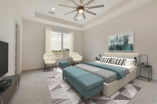 bedroom featuring a raised ceiling, ceiling fan, and light carpet