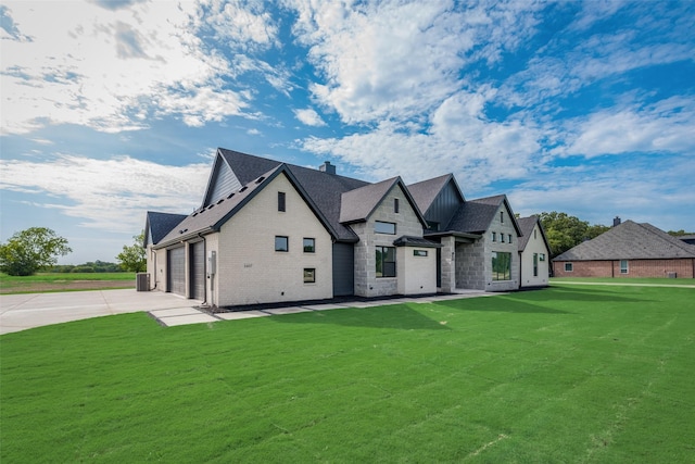 view of front of house with a front yard and a garage