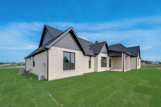 rear view of house featuring a patio and a lawn