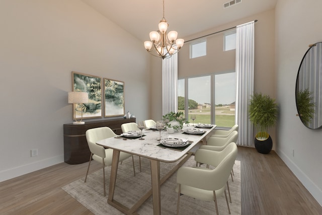 dining space featuring a high ceiling, a chandelier, and hardwood / wood-style floors