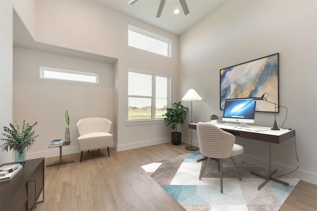 office featuring a high ceiling and light hardwood / wood-style flooring