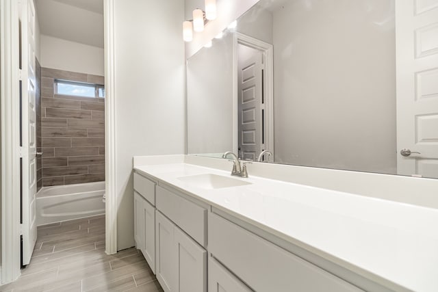 full bathroom with tiled shower / bath combo, vanity, tile patterned floors, and toilet