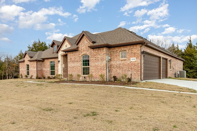 view of front of home featuring a garage and a front lawn