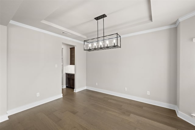 unfurnished dining area featuring a tray ceiling, dark hardwood / wood-style flooring, crown molding, and a notable chandelier