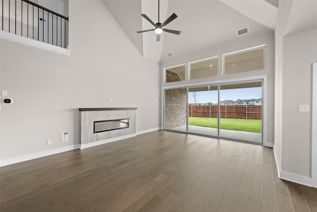 unfurnished living room featuring high vaulted ceiling, ceiling fan, and dark hardwood / wood-style floors