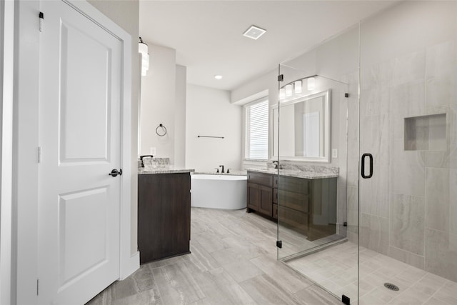 bathroom with shower with separate bathtub and vanity