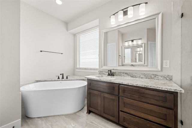 bathroom featuring tile floors, a washtub, and oversized vanity