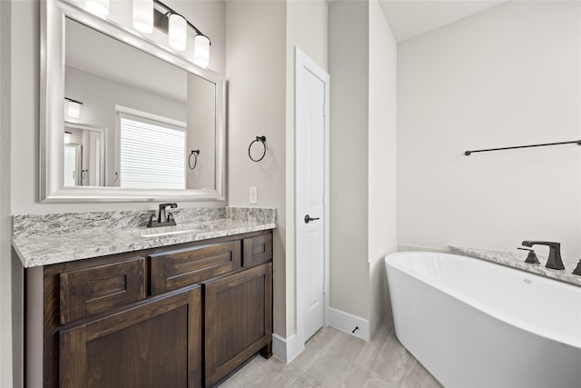 bathroom featuring a bathtub, tile flooring, and vanity