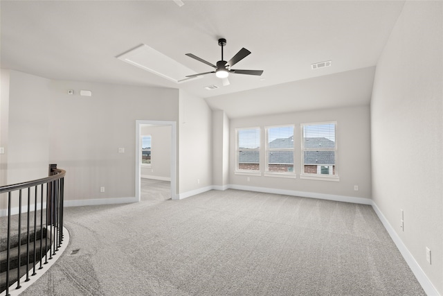 empty room with lofted ceiling, ceiling fan, and light colored carpet