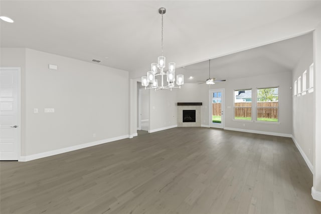 unfurnished living room featuring dark wood-style flooring, a fireplace, visible vents, baseboards, and vaulted ceiling