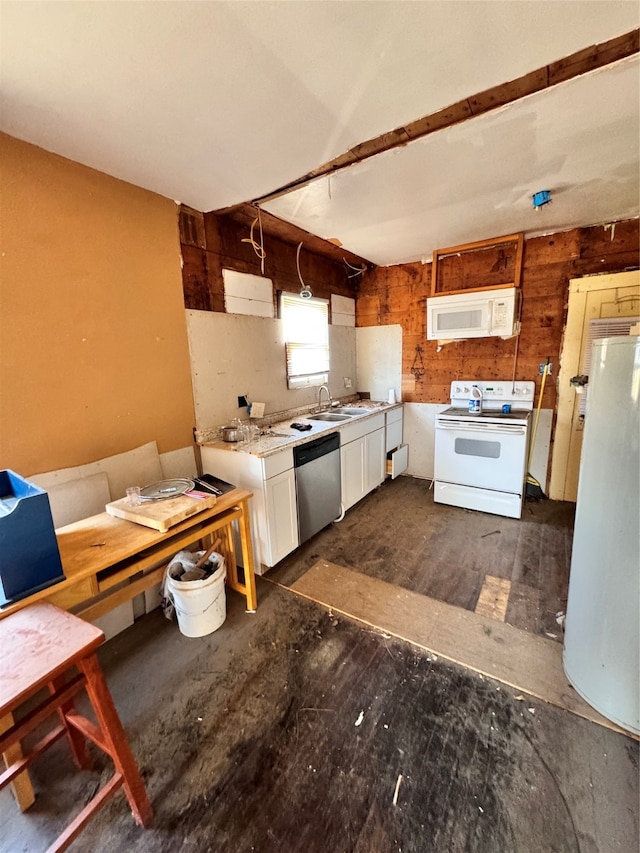 kitchen with white cabinets, wood walls, sink, white appliances, and decorative light fixtures