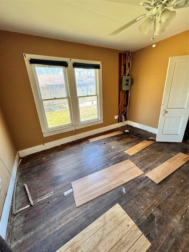 unfurnished room featuring ceiling fan and dark wood-type flooring