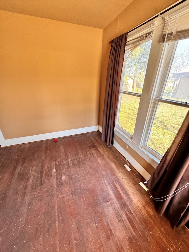 empty room with dark hardwood / wood-style flooring