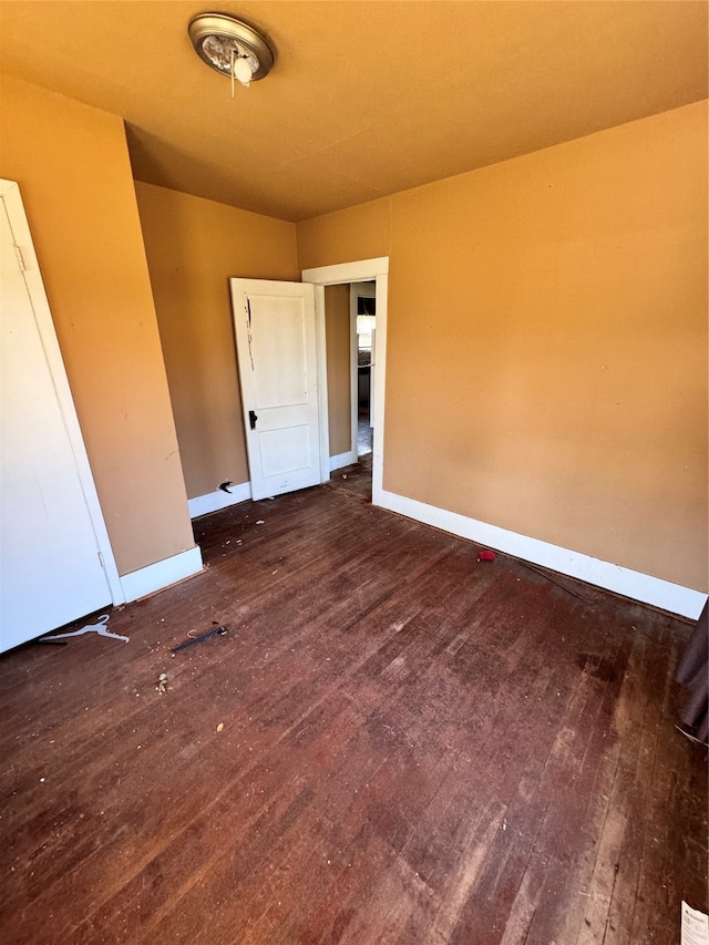 unfurnished room featuring dark hardwood / wood-style flooring