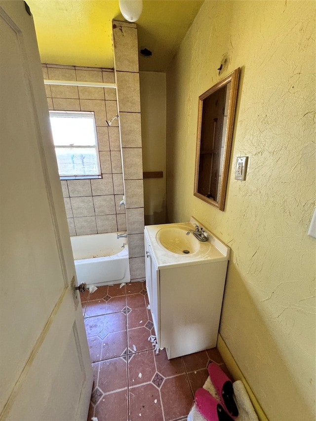 bathroom with tiled shower / bath, vanity, and tile patterned floors