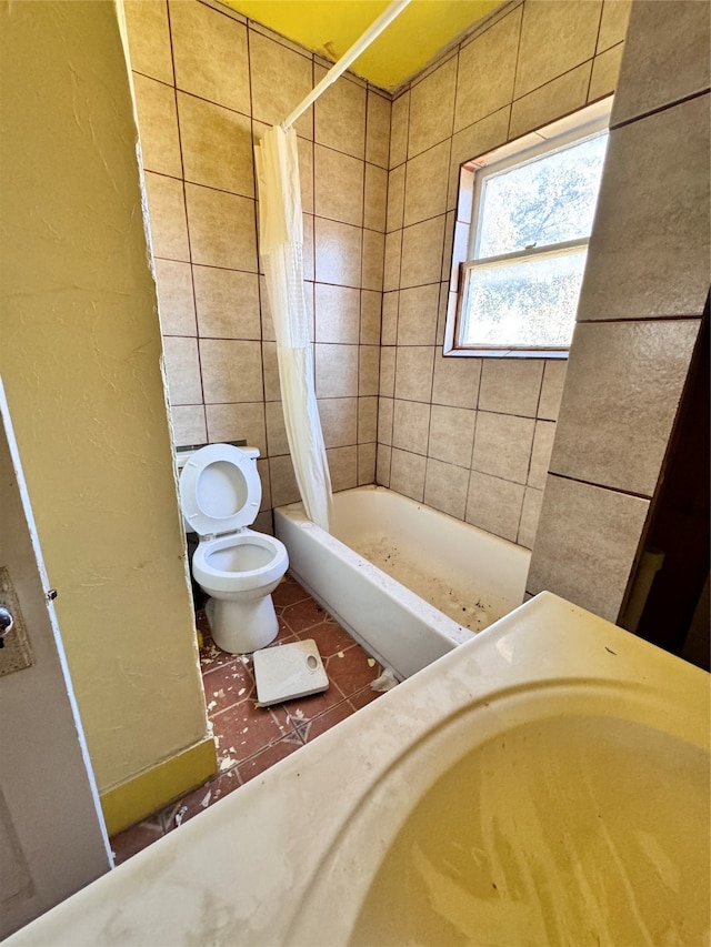 bathroom with shower / tub combo, toilet, and tile patterned floors