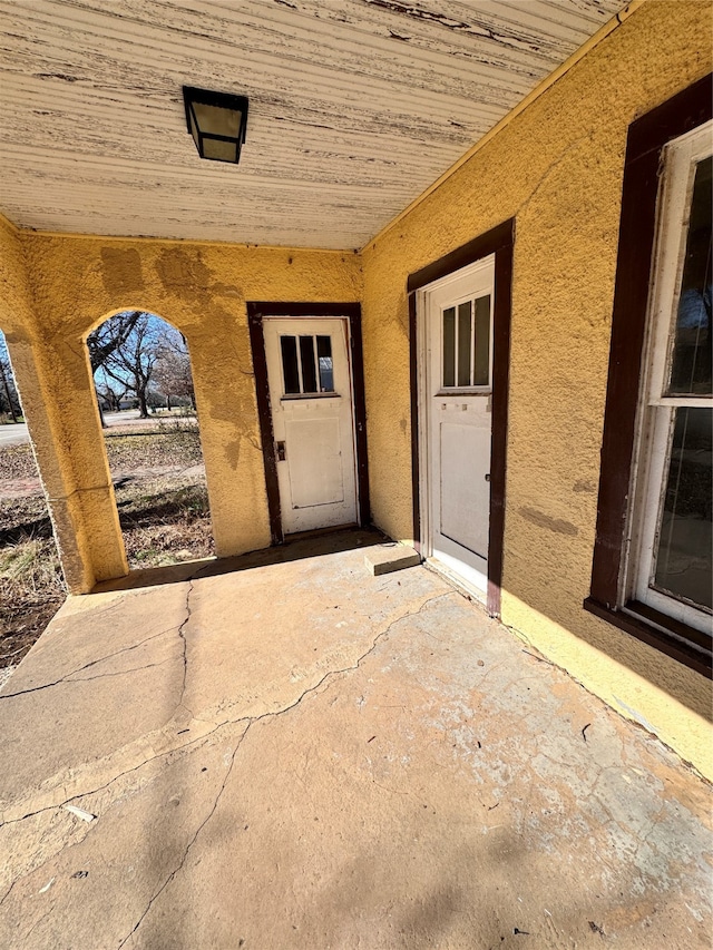 property entrance featuring a patio