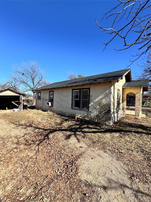 back of property featuring cooling unit and a carport