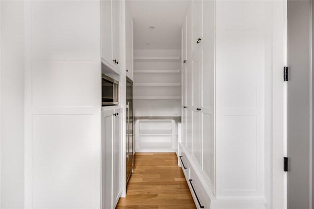 corridor with light wood-type flooring