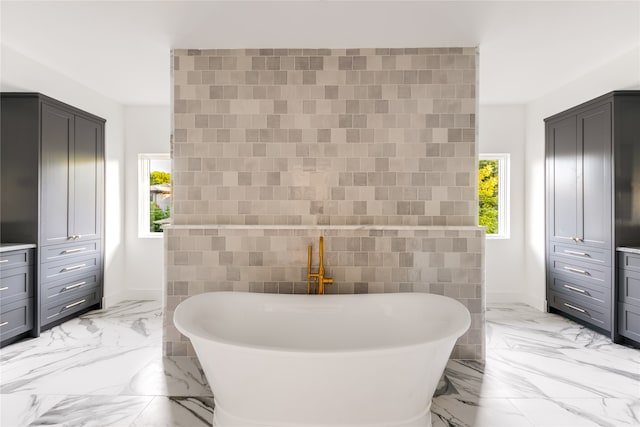 bathroom with tile patterned flooring and tile walls