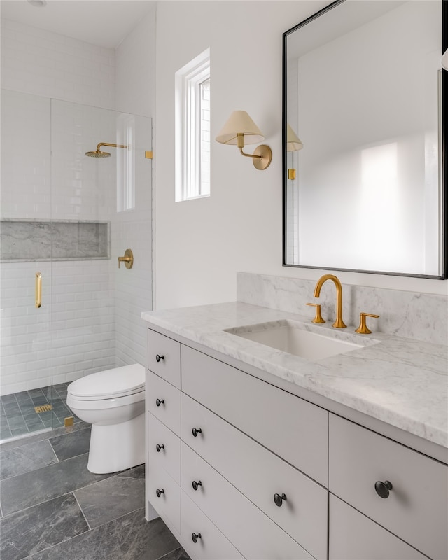 bathroom with tile patterned floors, vanity, walk in shower, and toilet