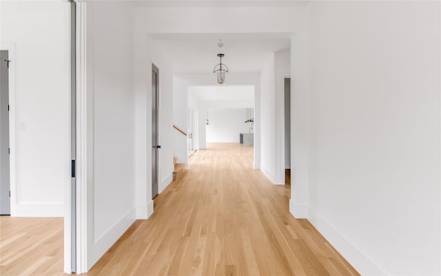 hallway with light hardwood / wood-style floors