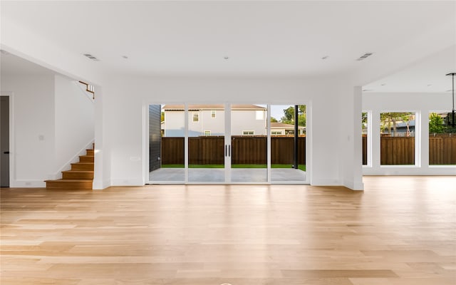 unfurnished living room with light hardwood / wood-style flooring