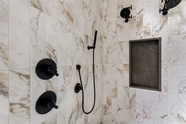 interior details featuring a tile shower