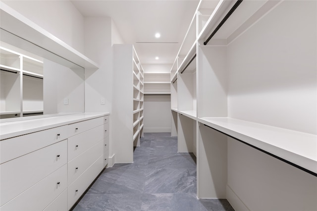 spacious closet with dark tile patterned floors