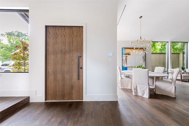 entryway featuring dark hardwood / wood-style flooring and a chandelier