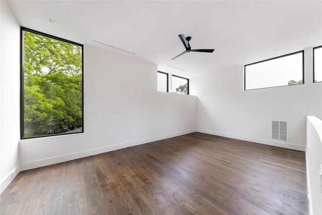 unfurnished room featuring ceiling fan and dark hardwood / wood-style flooring