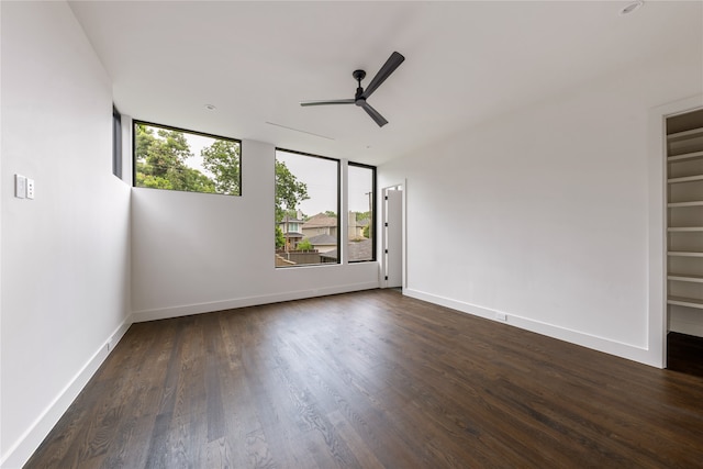 unfurnished room with dark wood-type flooring and ceiling fan