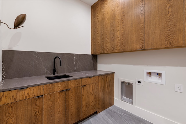 laundry area featuring hookup for an electric dryer, washer hookup, cabinets, wood-type flooring, and sink