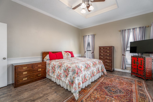 bedroom featuring ornamental molding, ceiling fan, and dark wood-type flooring