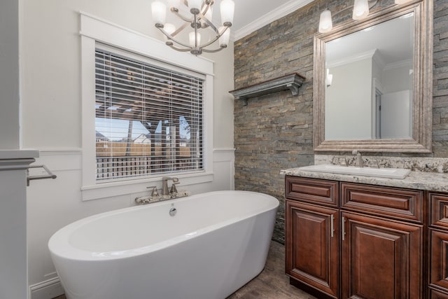 bathroom with a bath, crown molding, and vanity