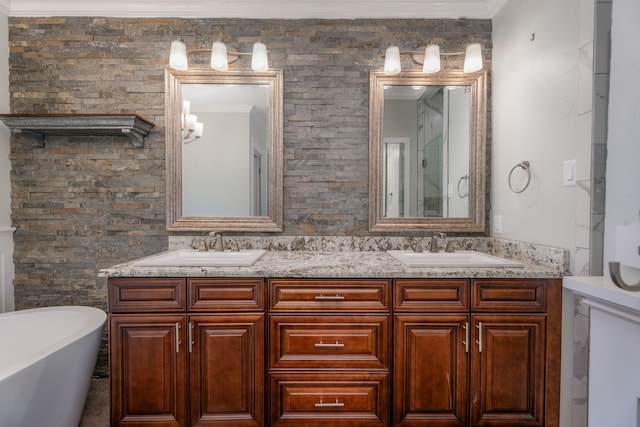 bathroom with a bath, ornamental molding, and vanity