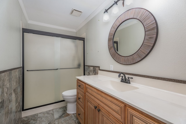 bathroom featuring walk in shower, crown molding, vanity, and toilet