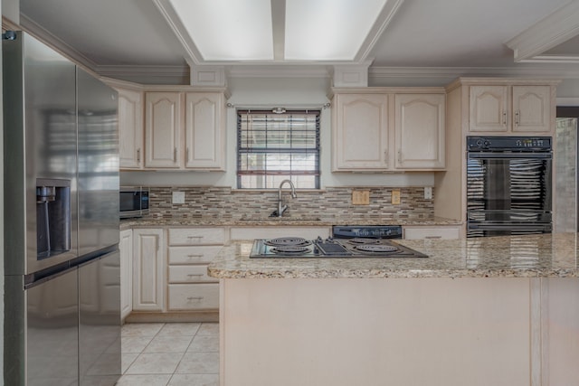 kitchen with light stone counters, light tile patterned flooring, sink, backsplash, and black appliances