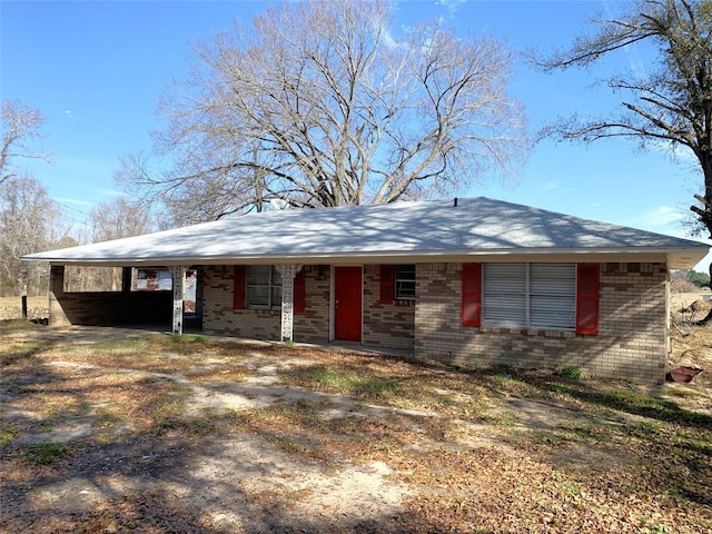 ranch-style house featuring a carport