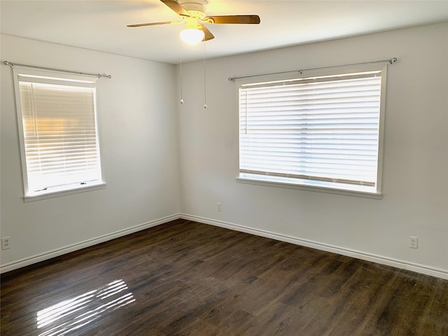 spare room featuring ceiling fan and dark hardwood / wood-style flooring