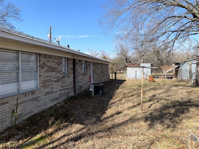 view of yard with cooling unit and a storage shed