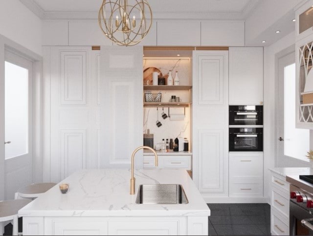 kitchen featuring sink, white cabinetry, black double oven, and an island with sink