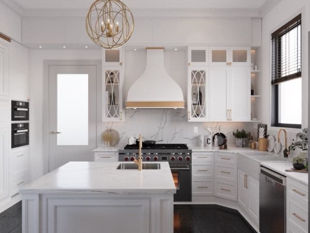 kitchen with a notable chandelier, premium range hood, stainless steel appliances, pendant lighting, and an island with sink