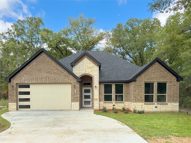 view of front of home featuring a garage and a front lawn